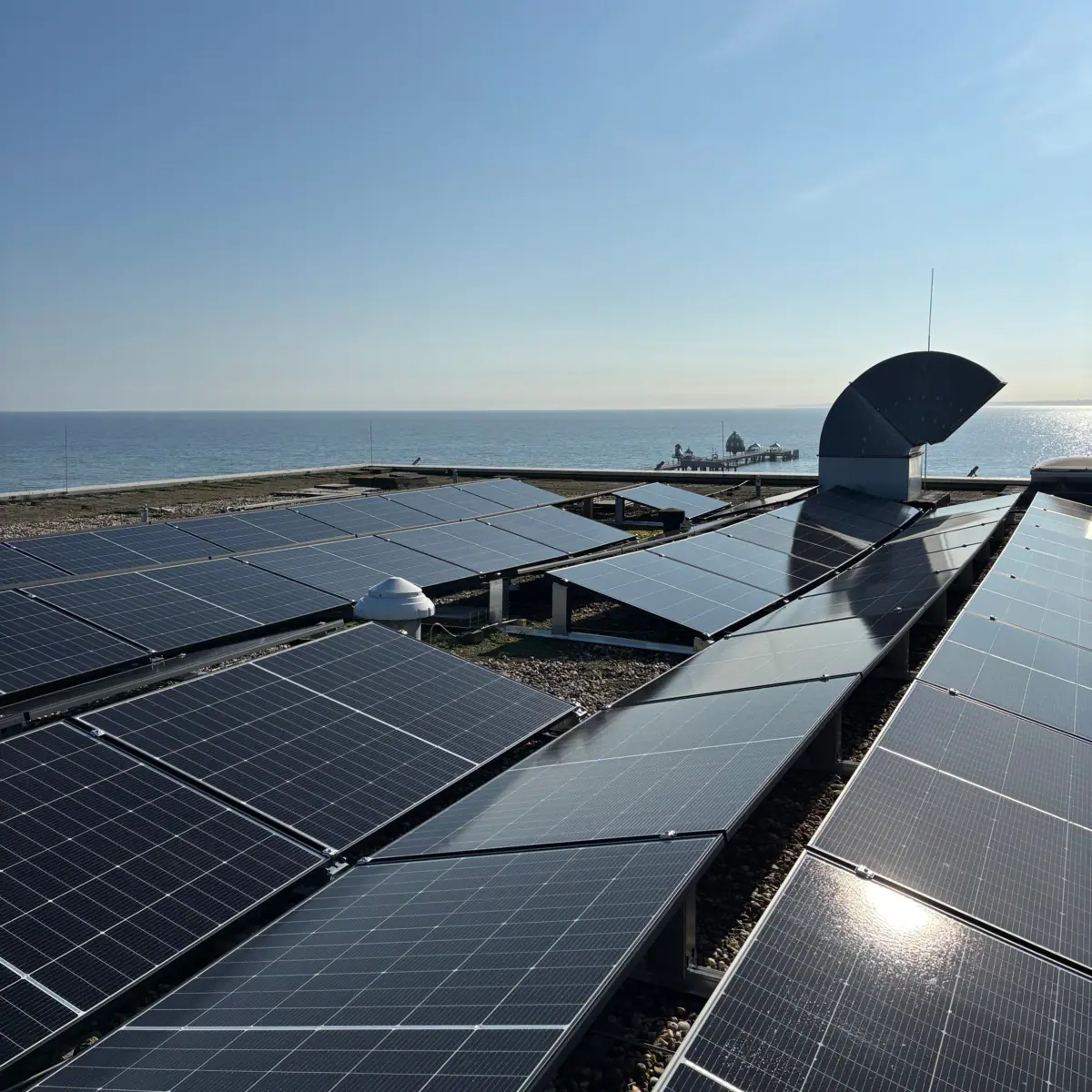 Solar panels on the beach under a clear sky