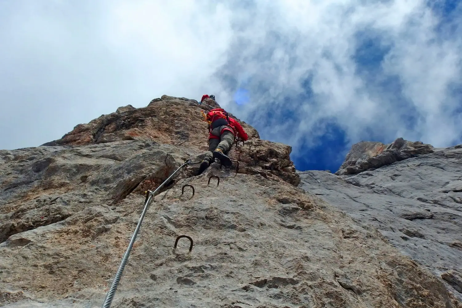 Climbing A person climbs up a rock face.