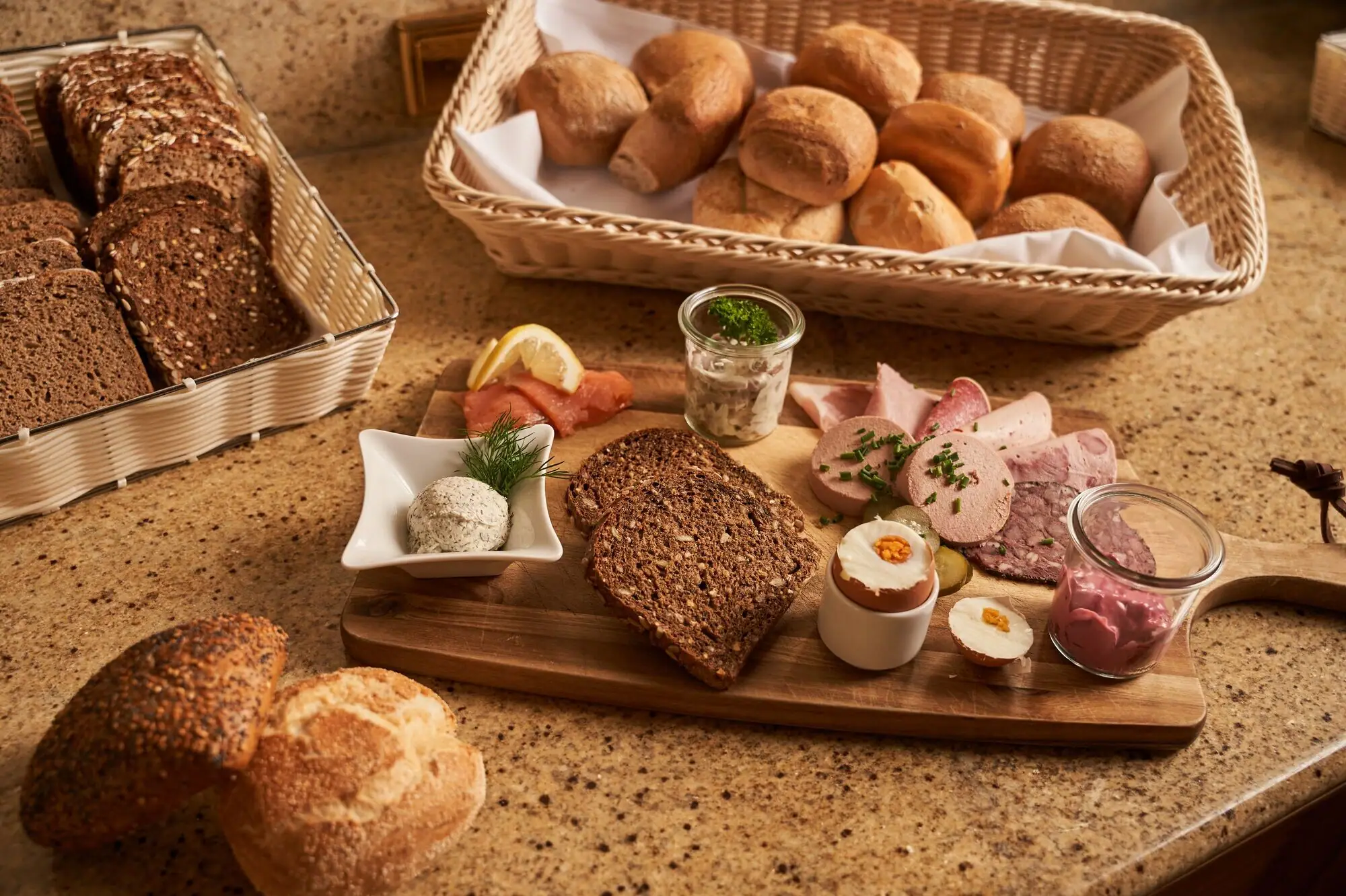 Wooden board with various baked goods on it.