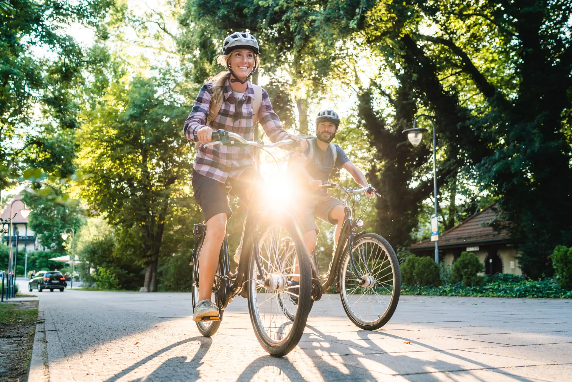 A man and a woman ride a bicycle