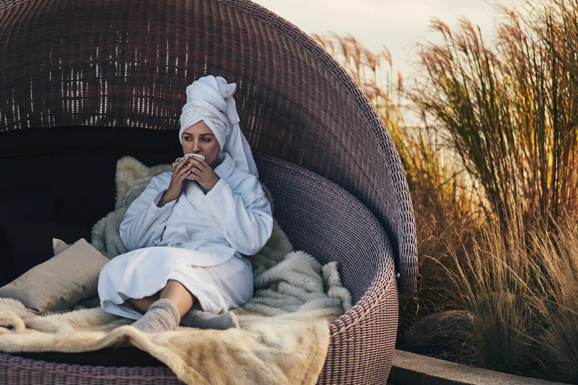 A woman sits on a chair.