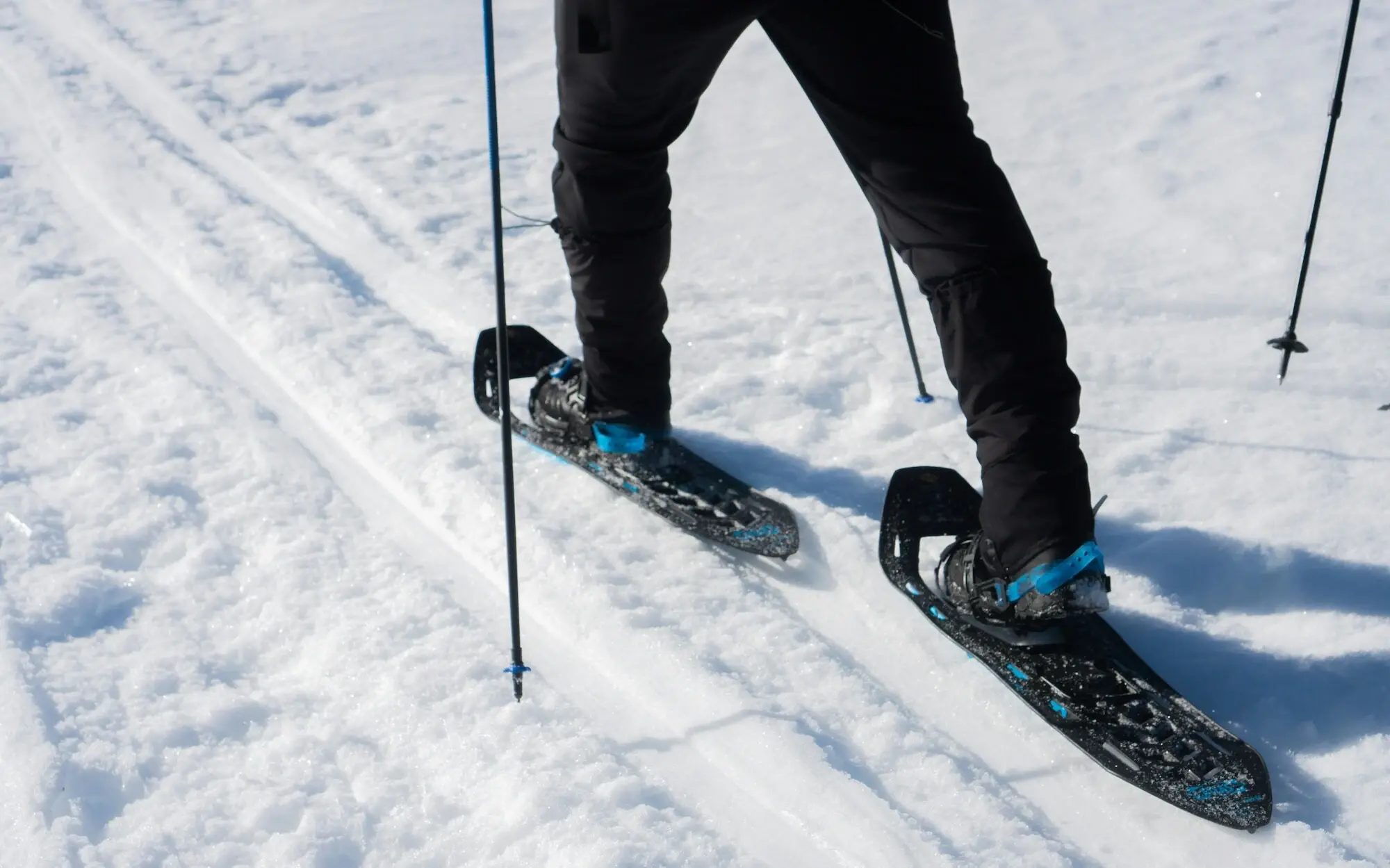 Person snowshoeing in the snow.