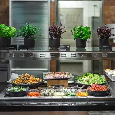 Restaurant at aja Bad Saarow Food on a shelf in a kitchen.