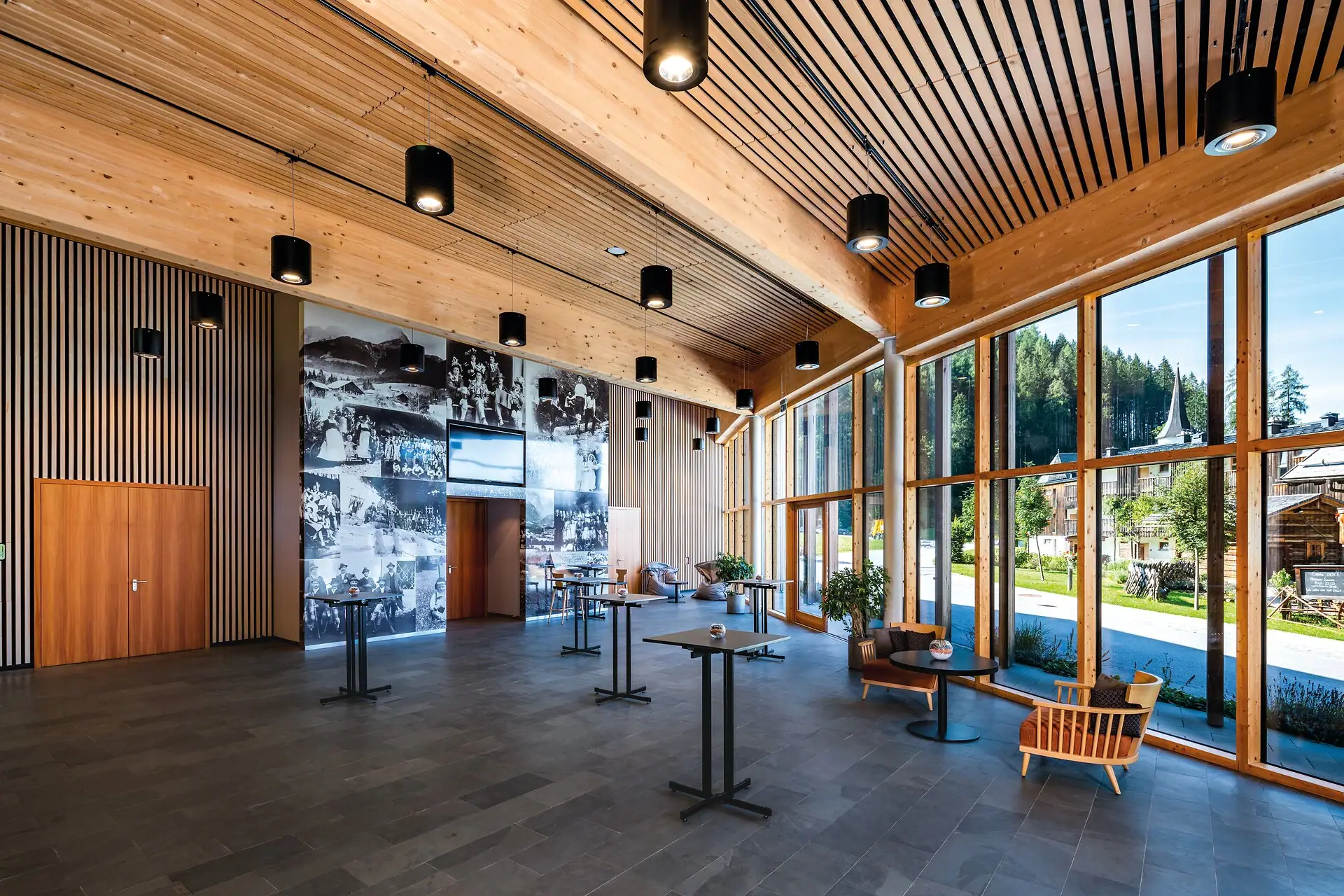 Foyer conference room A room with large windows and a large wall.