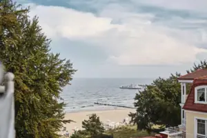 A beach with a boat in the water.