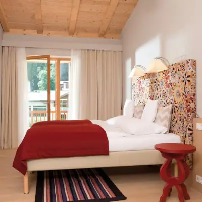 Holiday flat Werfenweng A bed with a colourful headboard in a room.