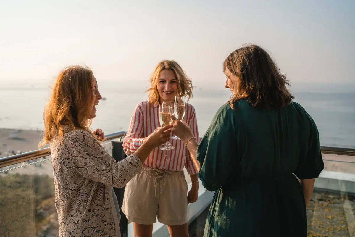 A group of women holding wine glasses outdoors.