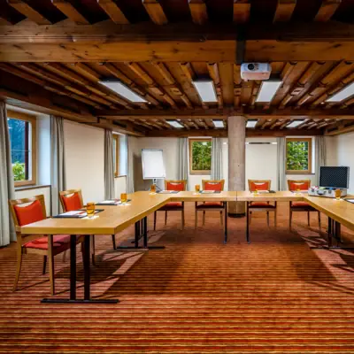 A room with a long table and chairs.