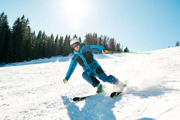 Skiing A person skis down a snowy slope.