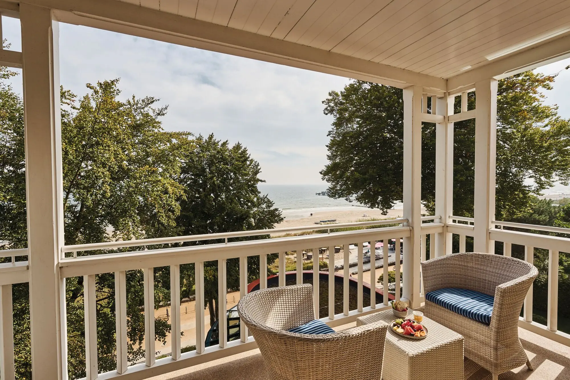 A balcony with chairs and a table on it.