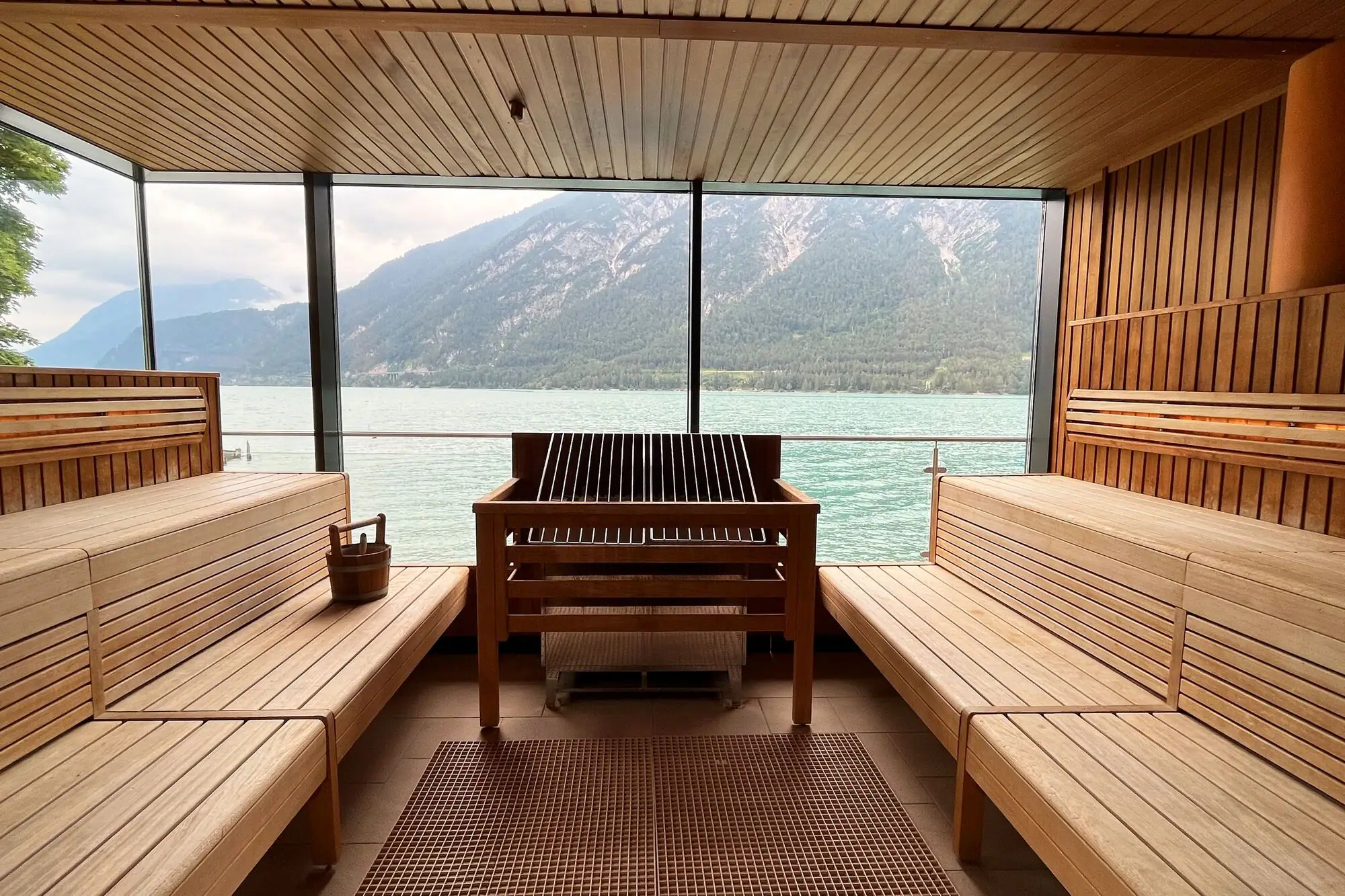 Sauna with panoramic view A sauna with a view of the water and mountains.