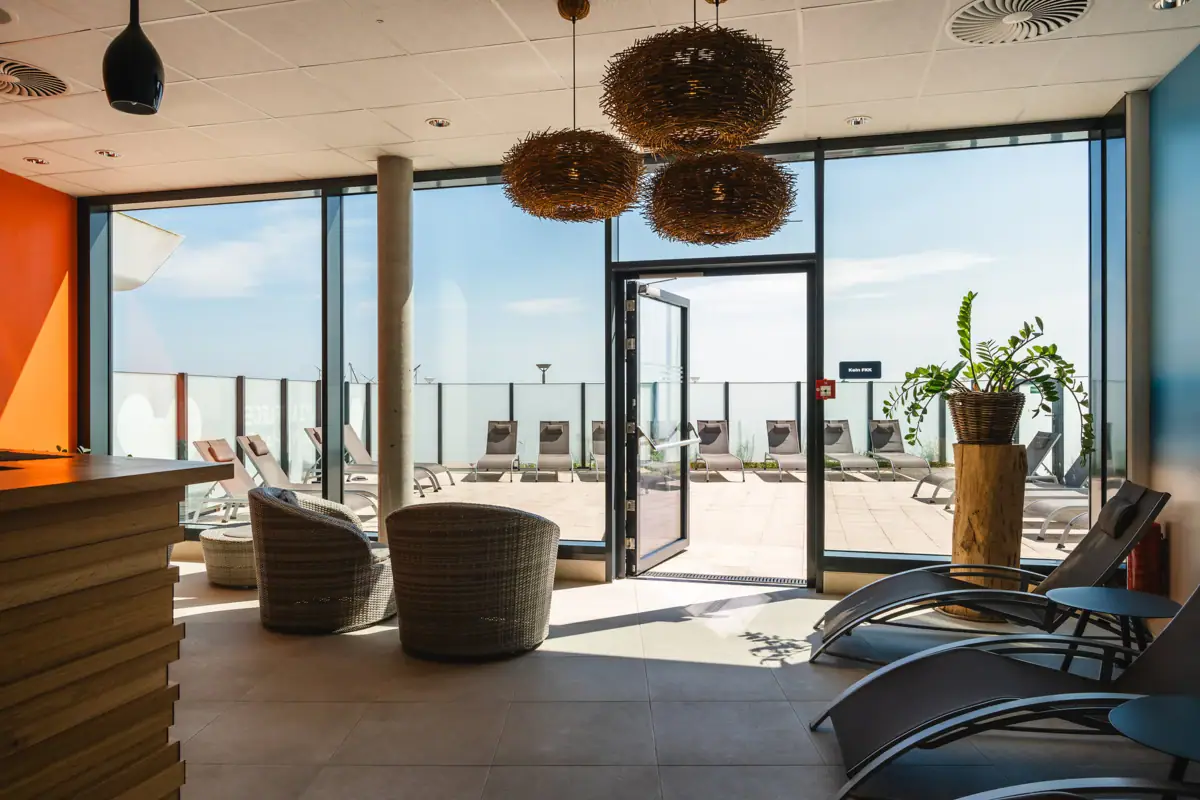 A room with chairs and a glass door.