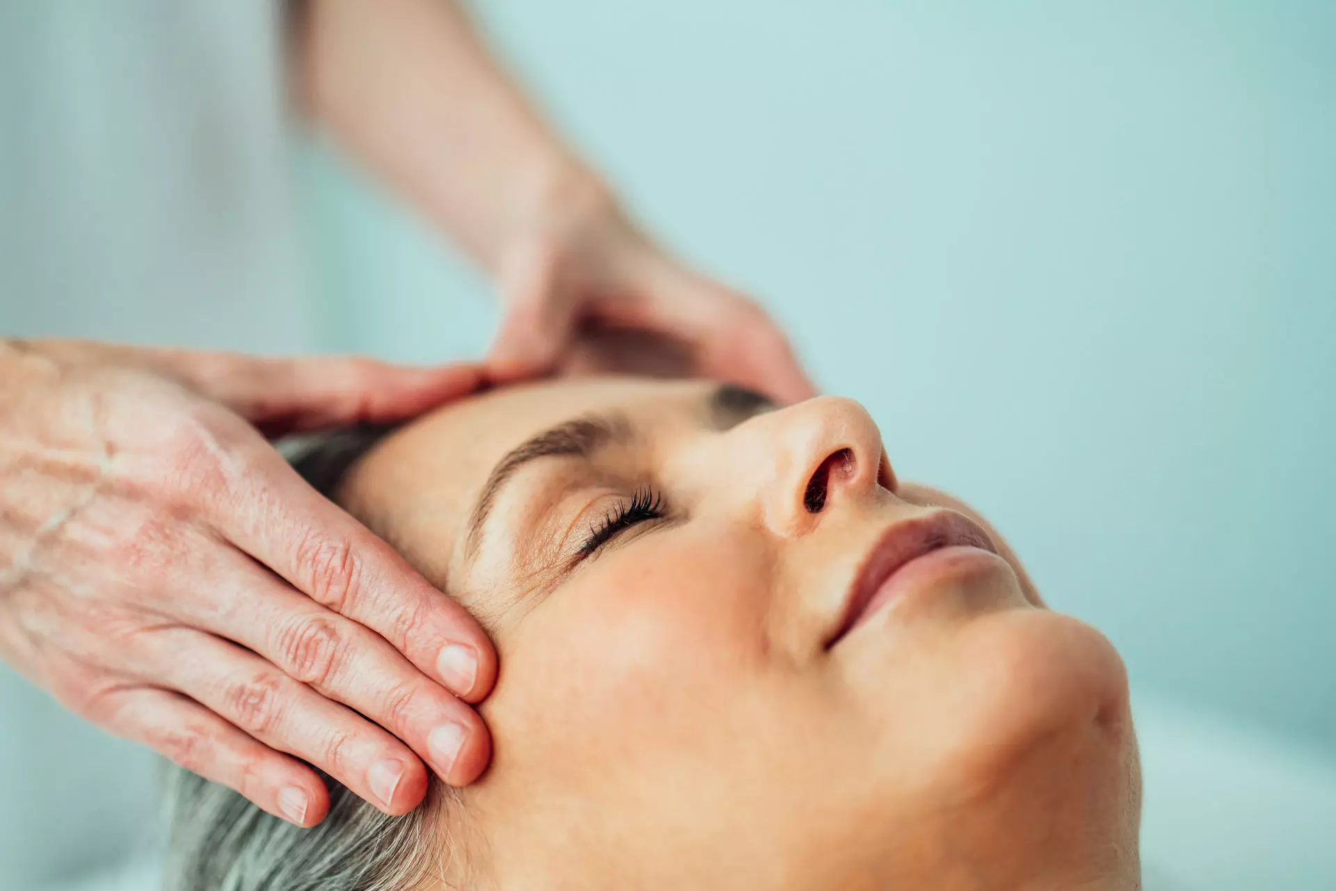 Cosmetics A person massages a woman's head.