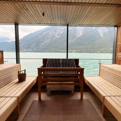 A room with a view of the water and mountains.