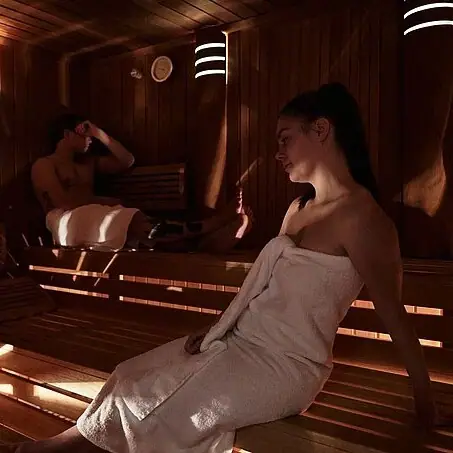 A woman and a man in a sauna.