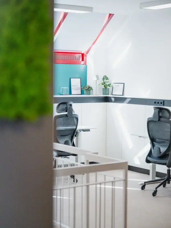 Chairs in a room with white walls and a white banister
