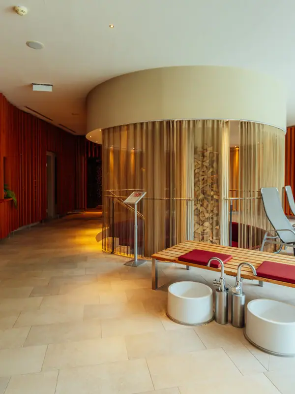 A room with a glass structure and a bench.