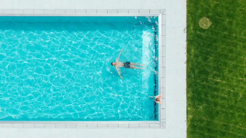 A group of people are swimming in a pool.
