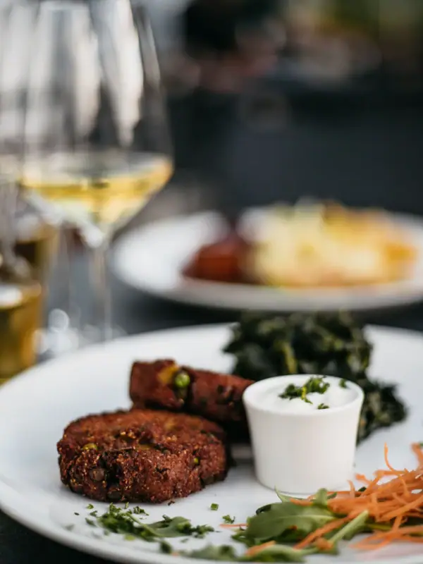 A plate of food and a glass of wine.