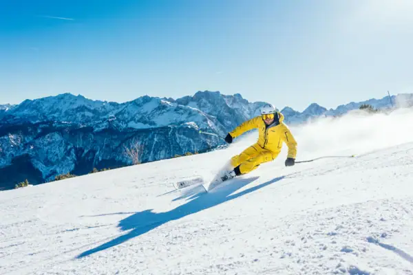 Skiing A person skis down a snow-covered mountain.