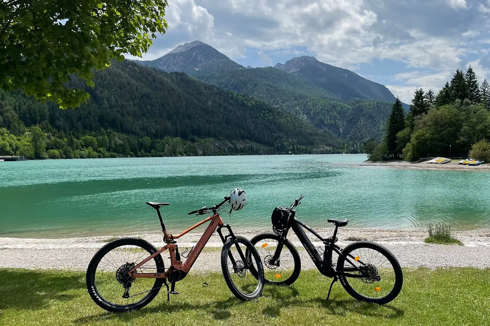 E-MTB on the shores of Lake Achensee Two bicycles next to a body of water