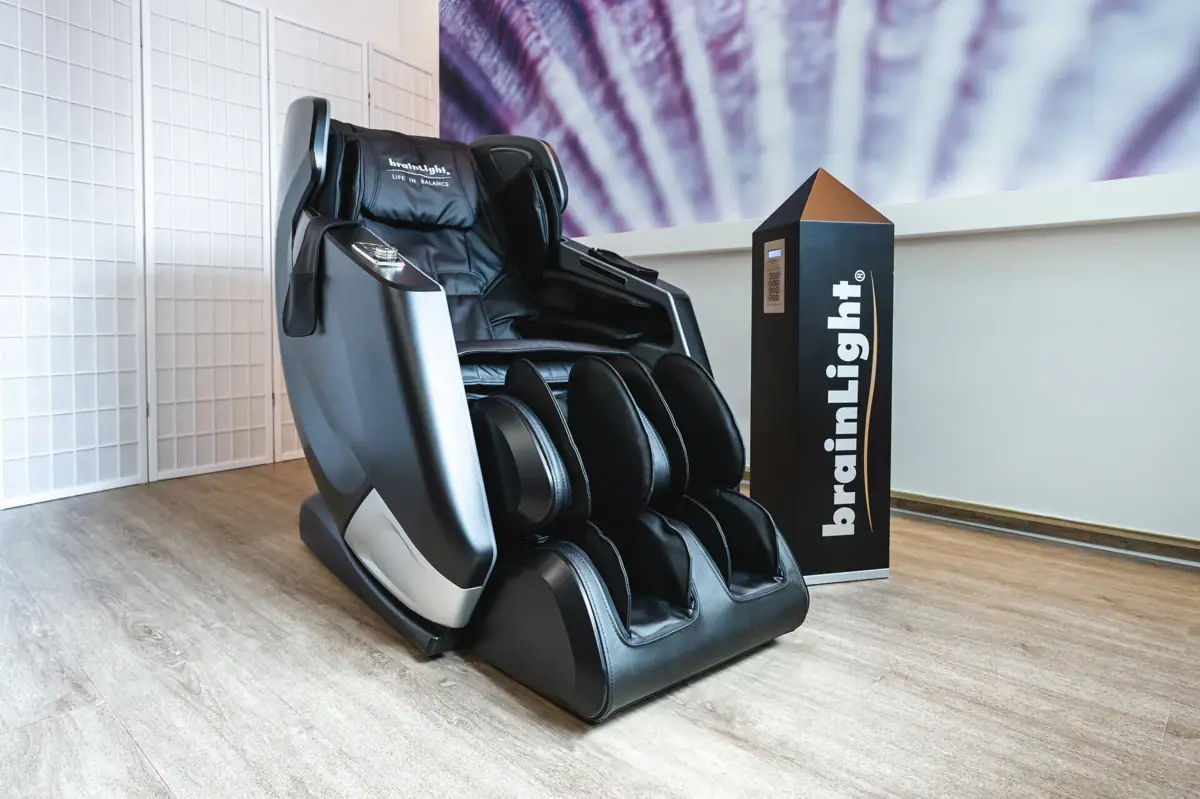 Black massage chair in a room.