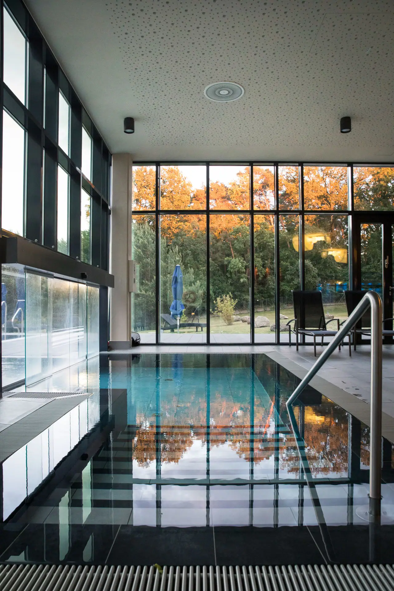 Access to the outdoor pool with large glass wall and large window.