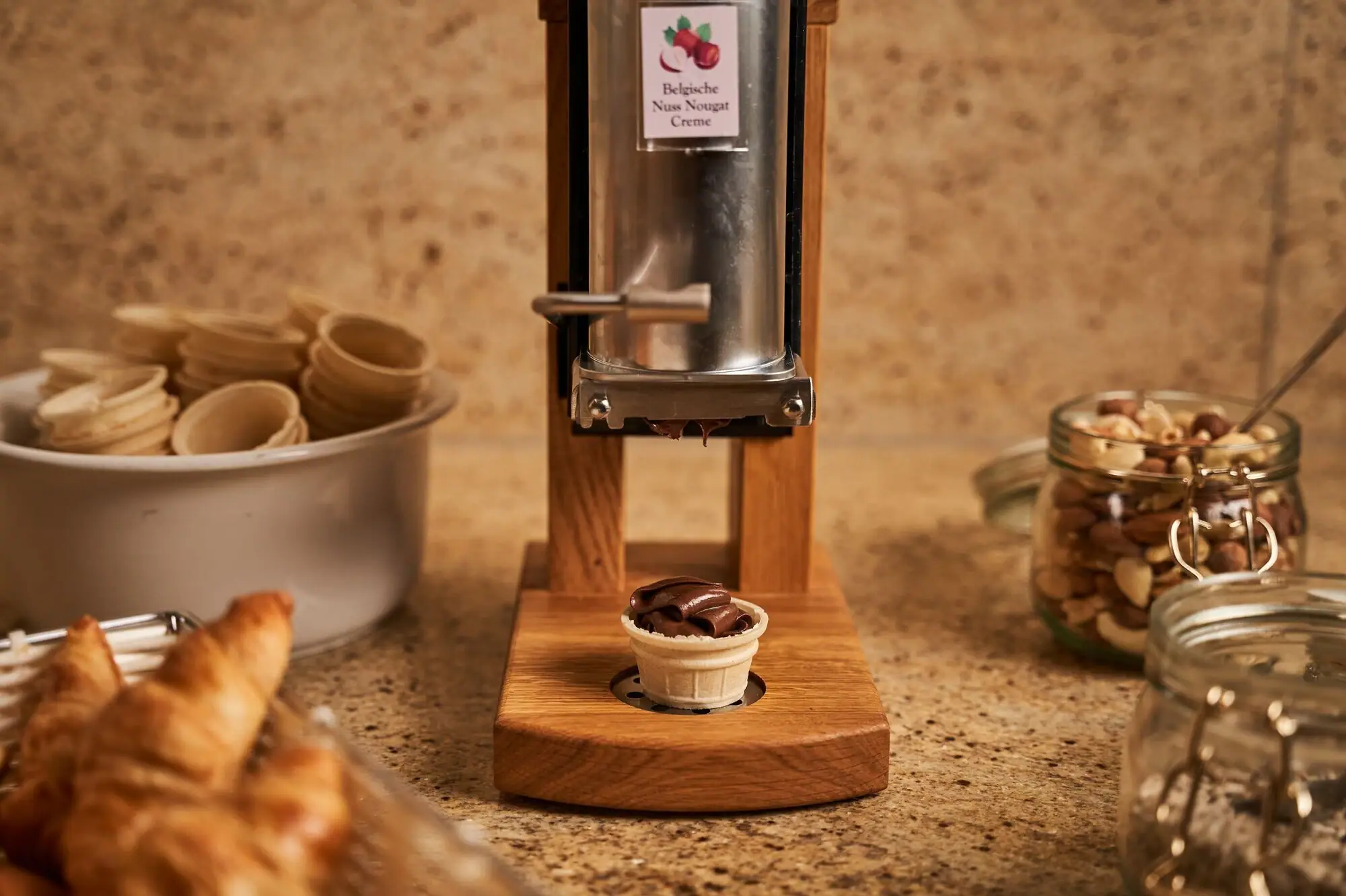 Nut butter machine A machine with a cone on a wooden stand.