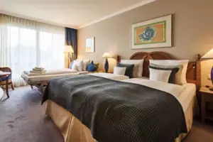 One bedroom with two single beds and one large bed.