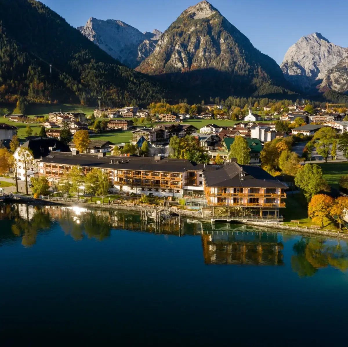 City on the water with trees and a clear sky.