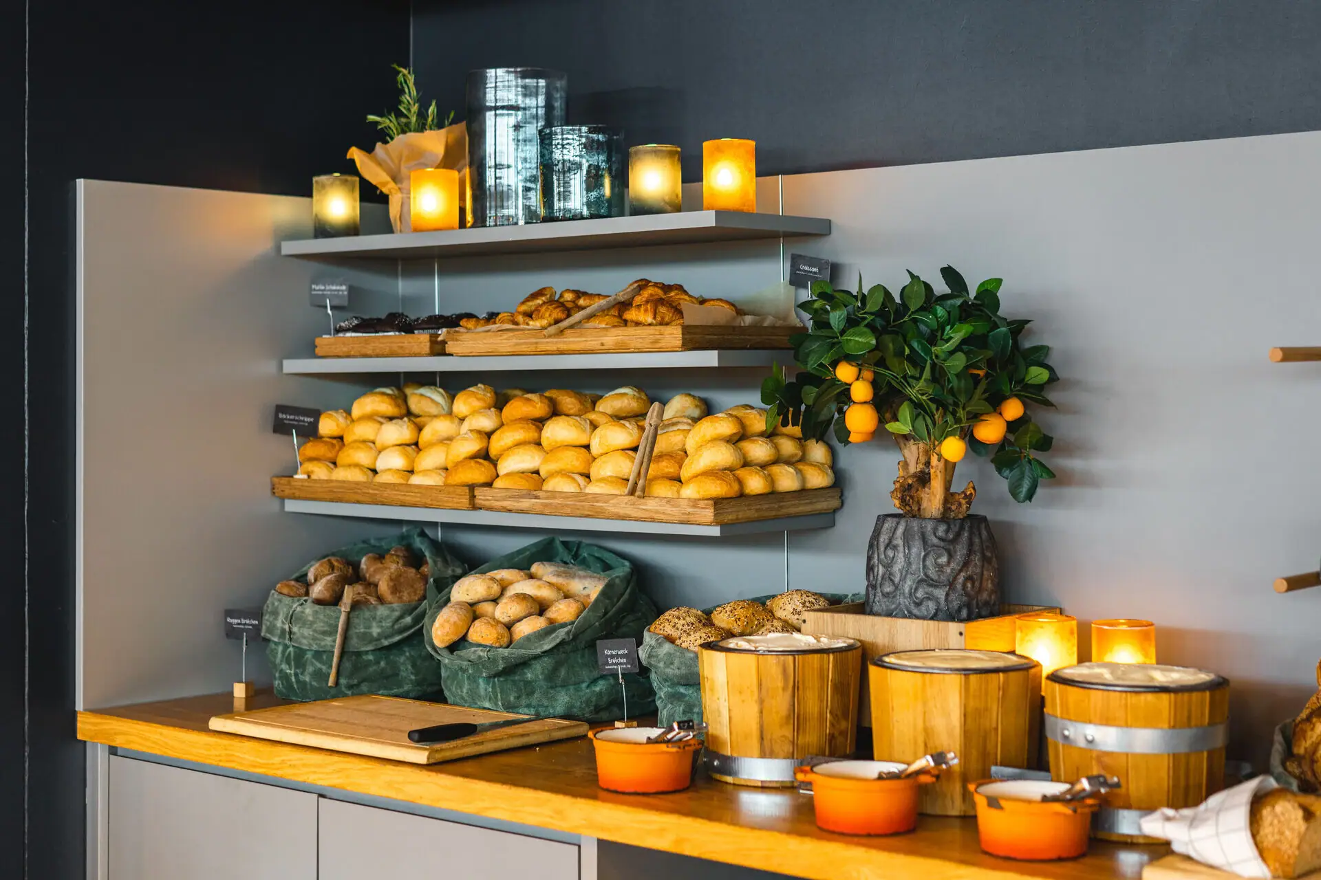 Bread roll station A shelf with bread and oranges.