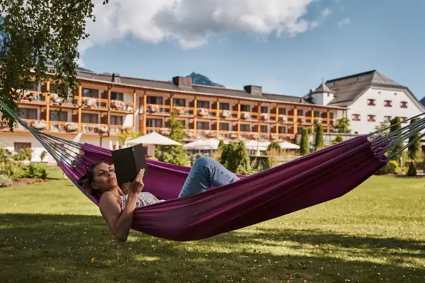 A woman lies in a hammock.