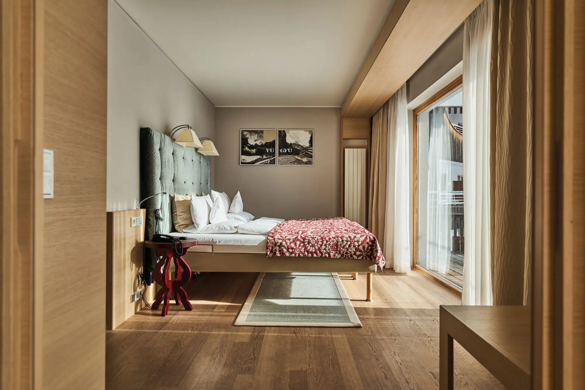 A modern hotel room with a large bed and a carpet underneath.