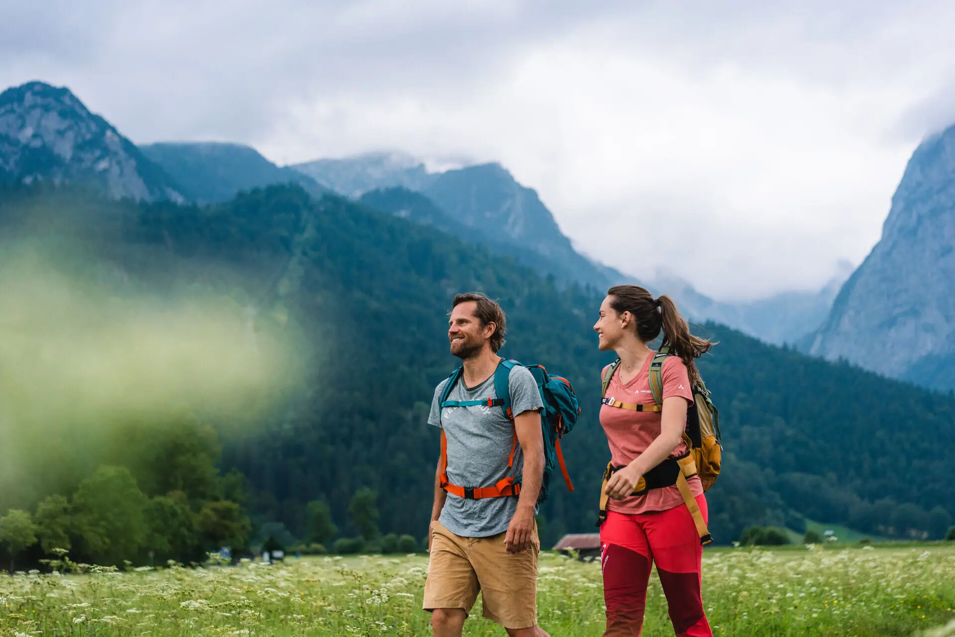 A man and a woman are walking in a field.
