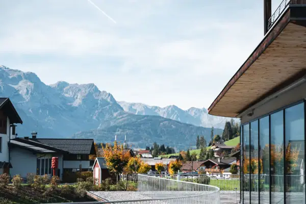 View A building with a glass door and a mountain range in the background.