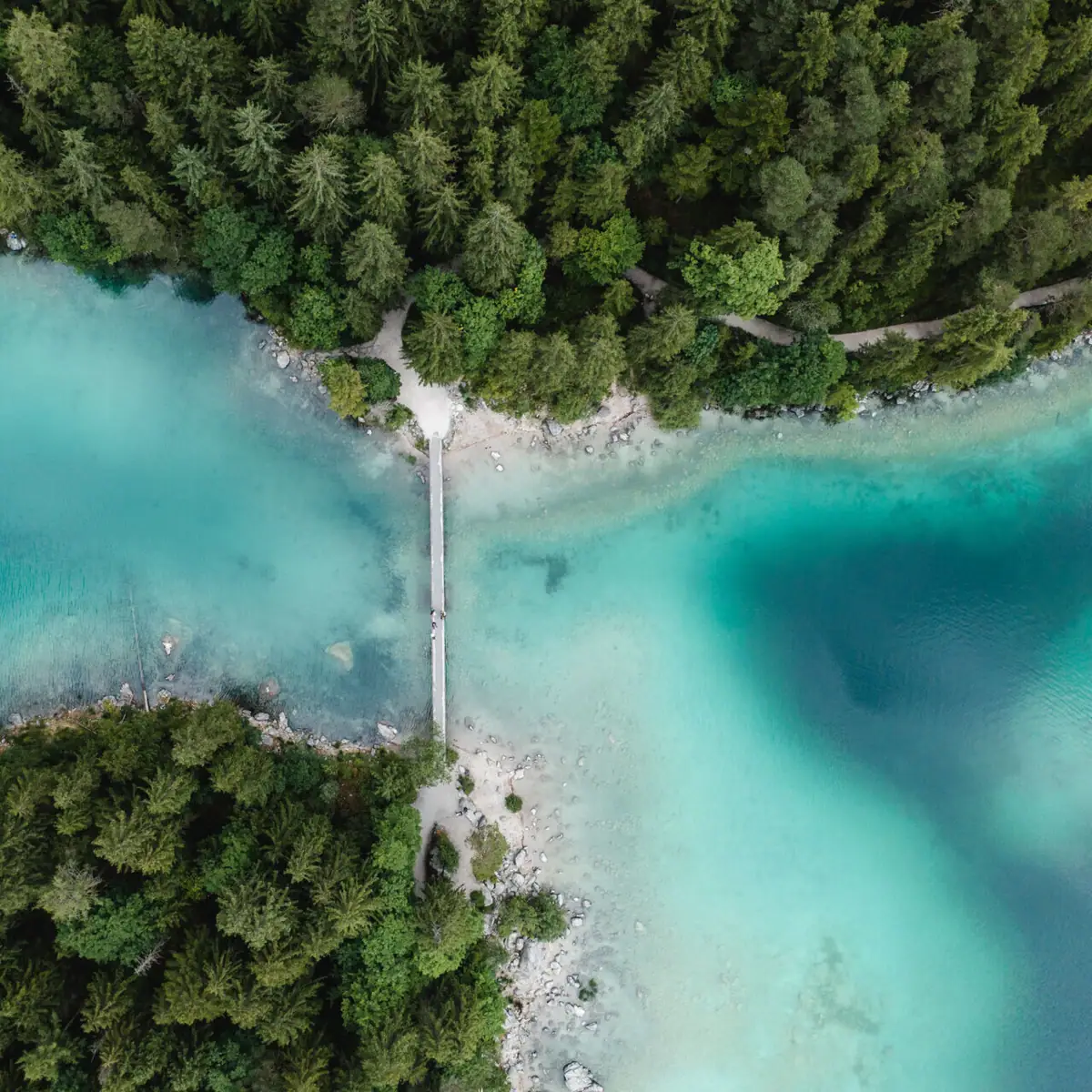 Eibsee Bridge over a body of water with trees in the background.