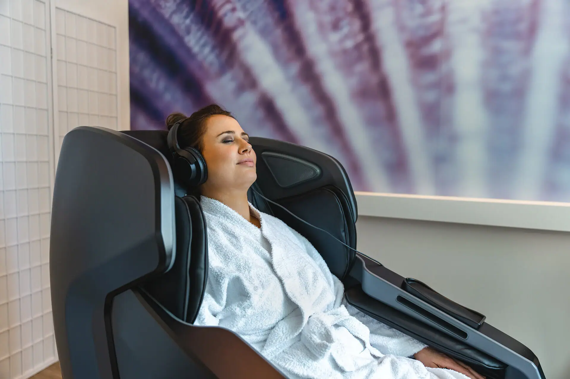 aja SPA A woman in a bathrobe with headphones.