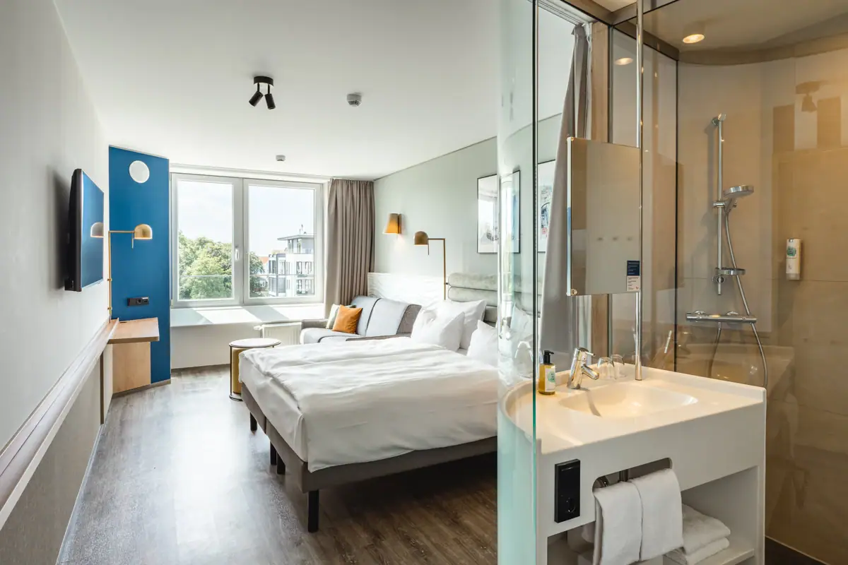 A room with a bed and a shower.