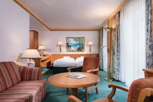 Comfort double room with balcony or terrace A room with a bed and a table.