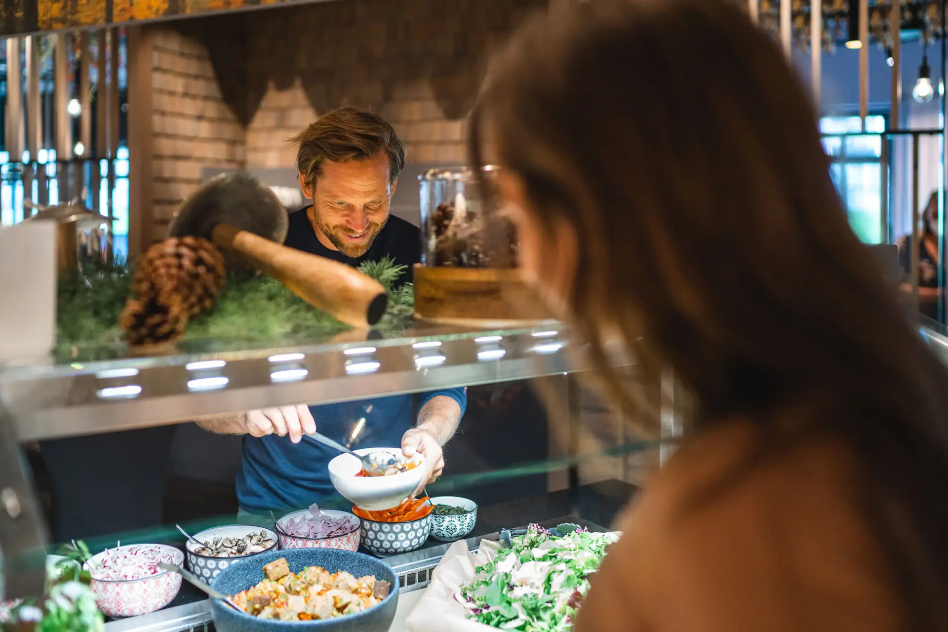 A man and a woman eating in a restaurant.