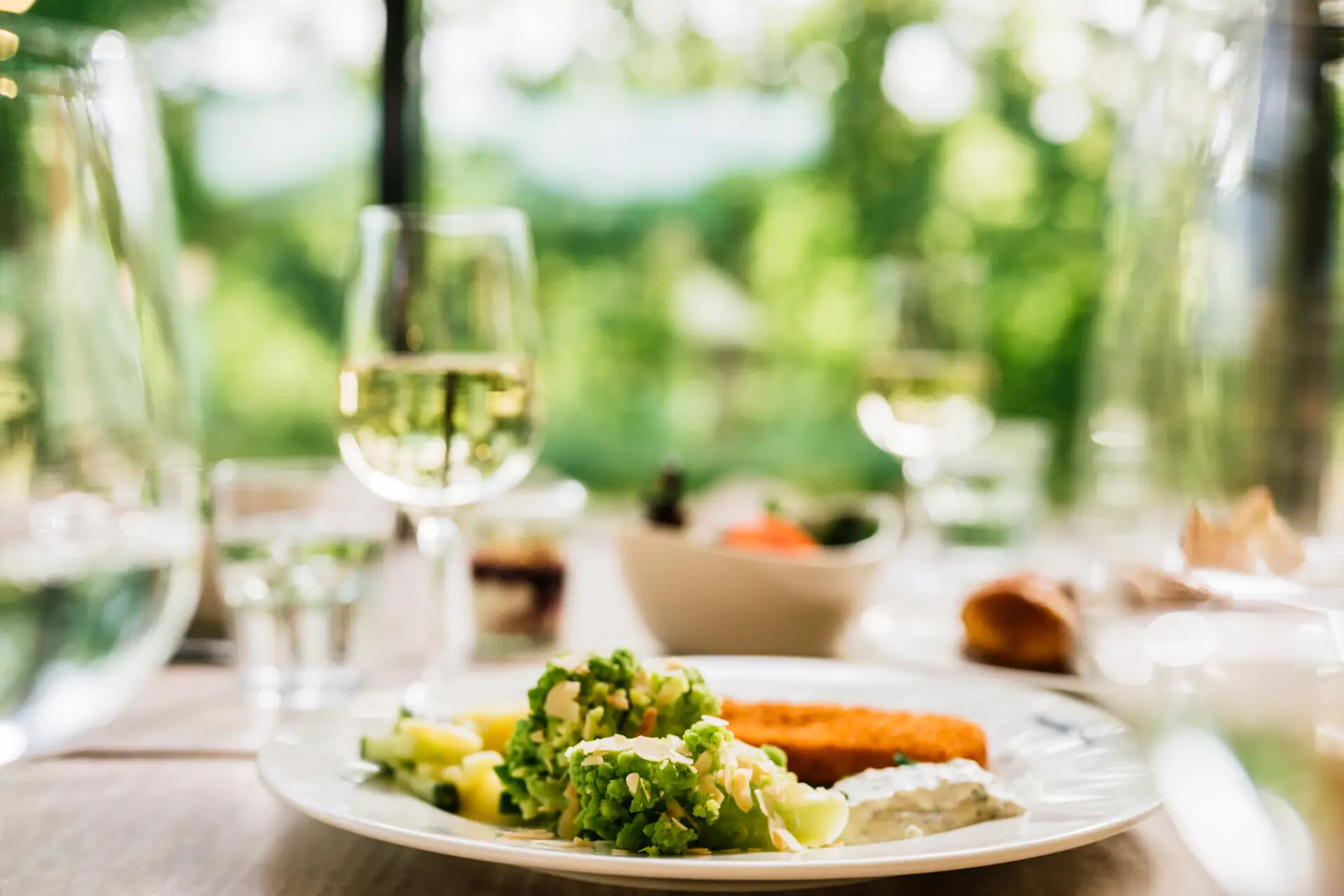 A plate of food and a glass of wine.