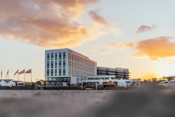 A building with flags in front of it at sunrise.