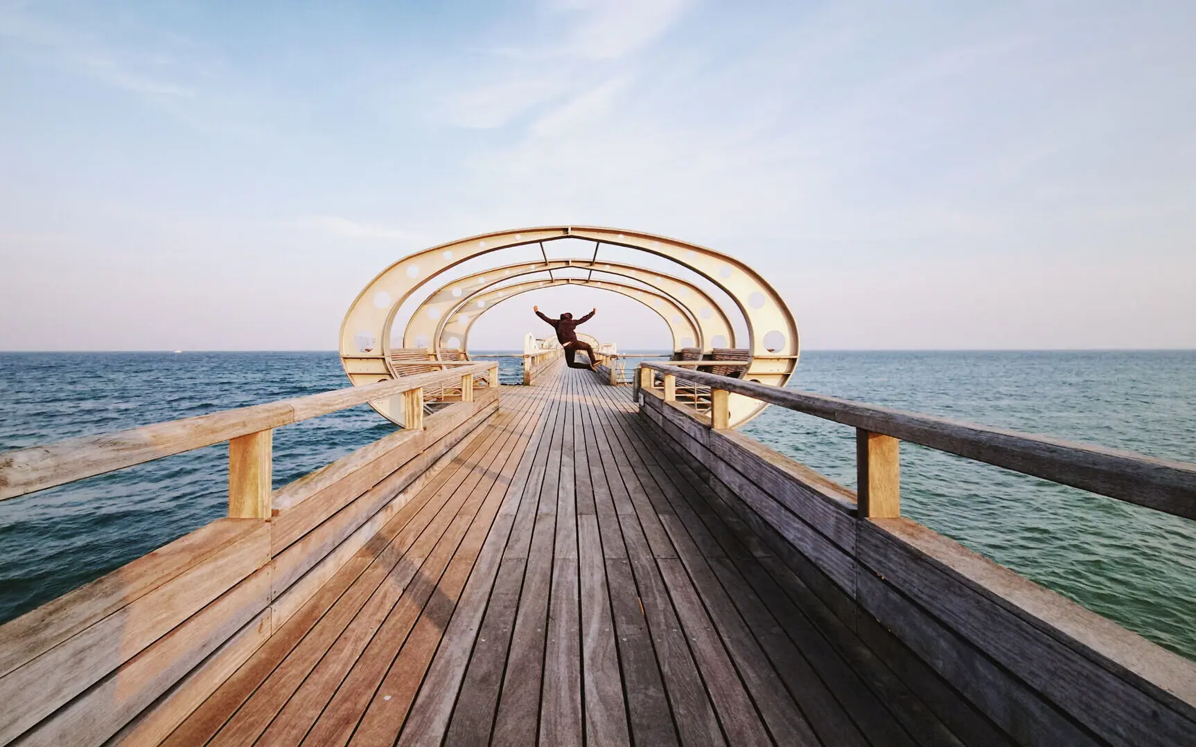 Person standing on a wooden footbridge