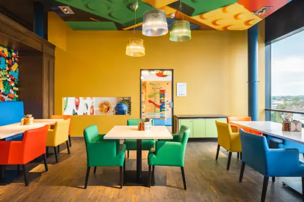 A room with colourful chairs and tables.