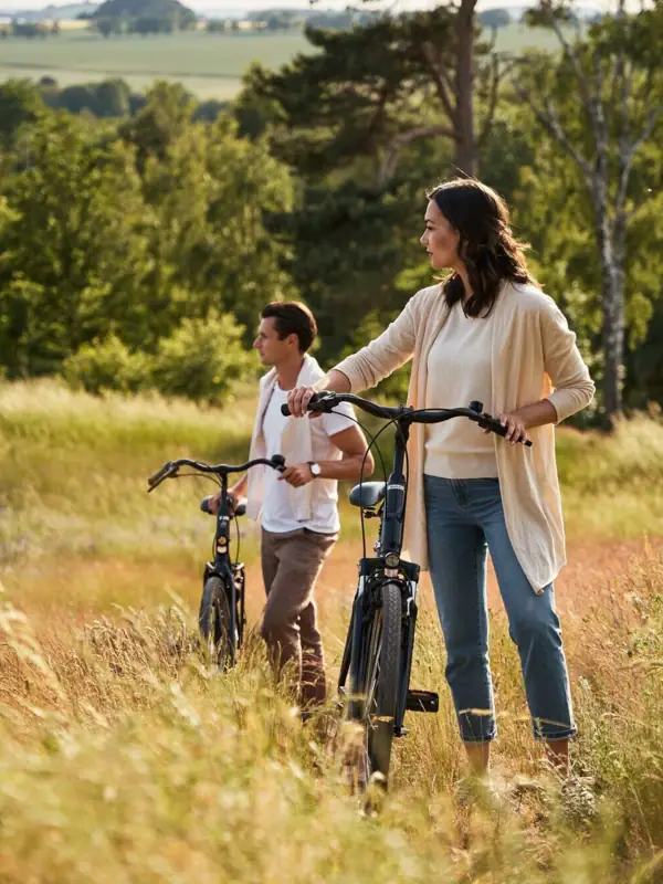 Bike tour A woman and a man are riding bicycles in a field.