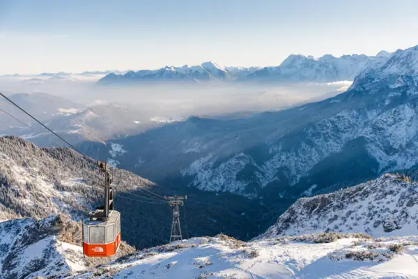 Cable car on a snow-covered mountain massif in the open air.