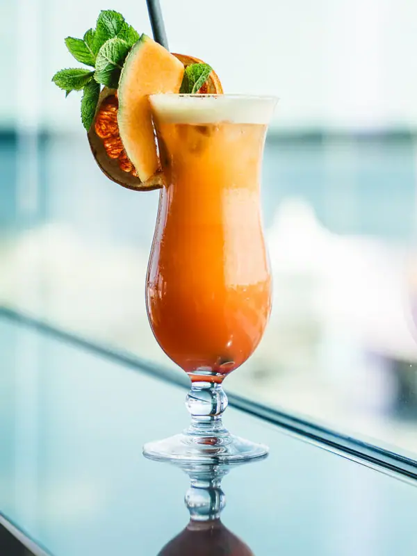 Cocktail A glass with a cocktail on a table.