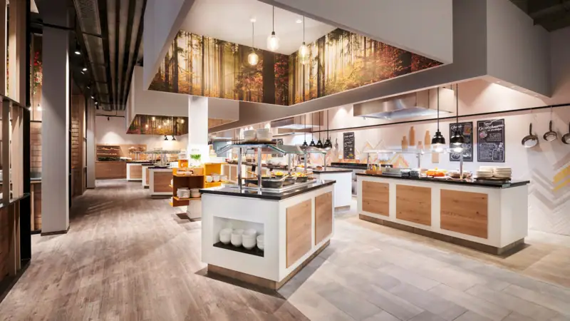 A restaurant with food on the counter.