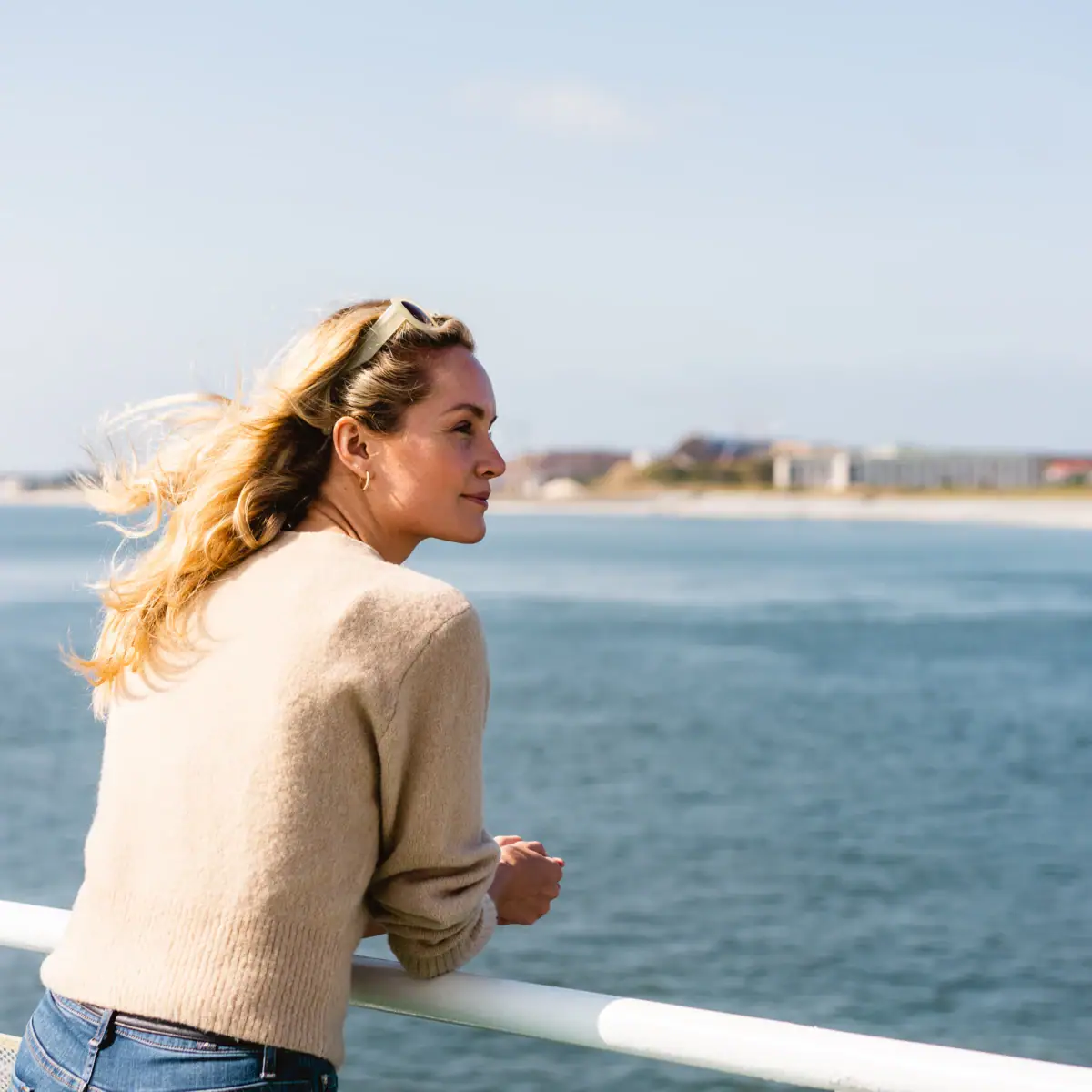 A woman looks out over the water.