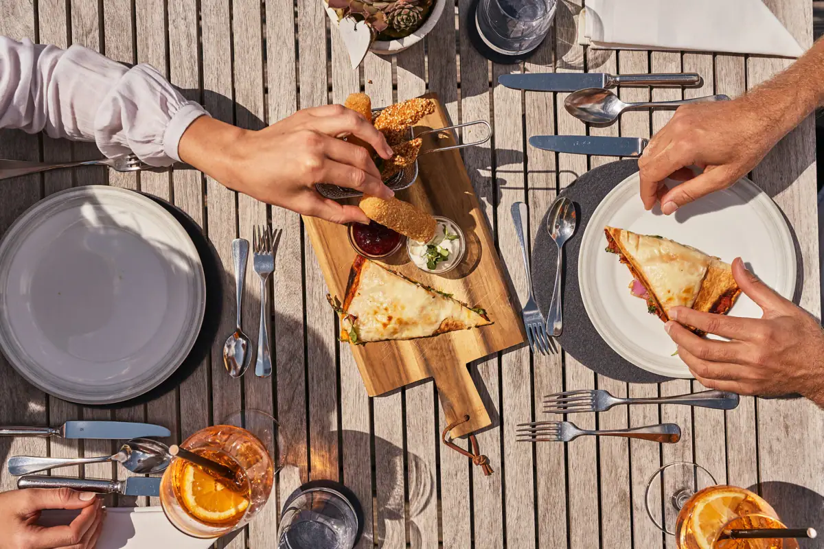 A person eats fast food at a table.